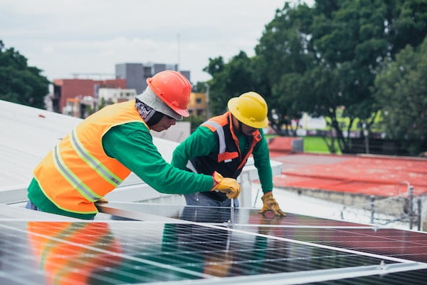 Two men working on a solar panel