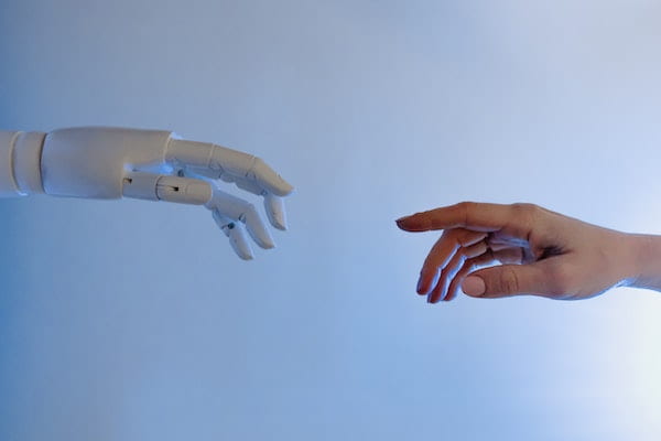 a robot hand reaching out to a human hand